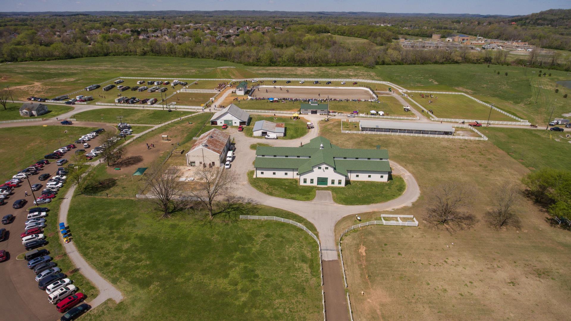 Aerial view of Harlinsdale Farm in Franklin, Tennessee showing the barn, arenas, and surrounding countryside